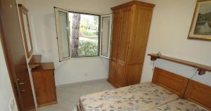 a bedroom with a bed and a window at Villaggio Turistico Sole e Mare in Nisporto