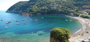 a group of boats in the water on a beach at Villaggio Turistico Sole e Mare in Nisporto +17 photos
