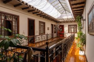 an ornaterium with a glass ceiling and a balcony with plants at La POSADA CUENCANA EN CUENCA in Cuenca