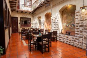 a restaurant with tables and chairs in a room at La POSADA CUENCANA EN CUENCA in Cuenca