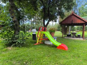 a playground with a slide in the grass at Wśród Drzew - Tykocin in Tykocin