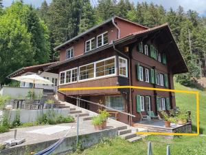 a house is being built on a hill at Chalet Sonnenheim, Wohnung mit Panoramafenster in Adelboden +9 photos