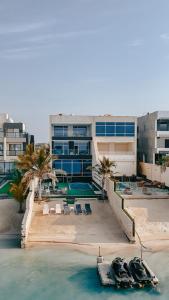 a resort with boats in the water next to a building at فيلا تولاي in Dahaban