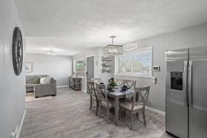 a kitchen and dining room with a table and a refrigerator at Tucson Oasis by Rather Be Properties in Tucson