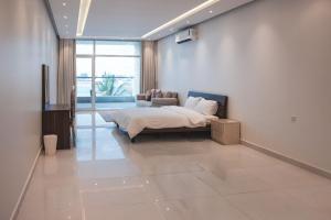 a bedroom with a bed and a couch in a room at فيلا تولاي in Dahaban +33 photos