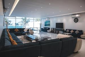 a living room with a couch and a television at فيلا تولاي in Dahaban