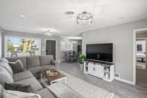 a living room with a couch and a flat screen tv at Tucson Oasis by Rather Be Properties in Tucson +31 photos