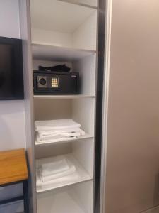 a closet with a refrigerator with a microwave at BlackBrick2 in Johannesburg +4 photos