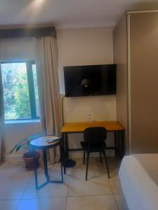 a room with a desk and a table and a chair at BlackBrick2 in Johannesburg