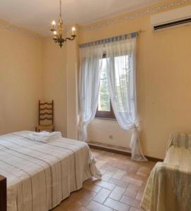a bedroom with a bed and a window at Casale Antico Mulino in Beroide