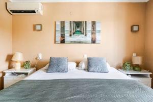 a bedroom with a large bed with blue pillows at Villa Amare in Benissa +44 photos