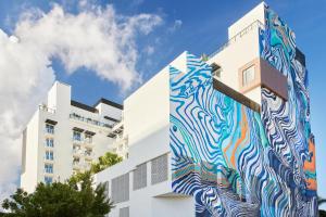 a building with a mural on the side of it at Arlo Wynwood Miami in Miami