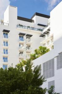 an apartment building with trees in front of it at Arlo Wynwood Miami in Miami +143 photos