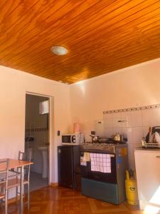 a kitchen with a stove and a table in it at Cabañas Wiñaypacha Putre in Putre