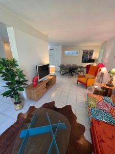 a living room with a couch and a tv at Appartement 188m2 in Crans-Montana