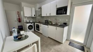 a kitchen with white cabinets and a white counter top at Bela House, By Home Match in Setúbal
