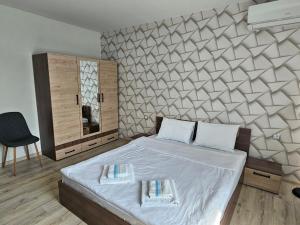 a bedroom with a bed with two towels on it at къща Чипровка in Chiprovtsi