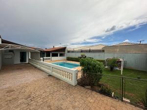 a house with a swimming pool in a yard at Aconchego do Lago in Espirito Santo Do Pinhal
