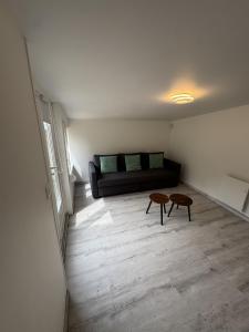 a living room with a couch and a table at Sam's cocoon in Vicq-sur-Nahon