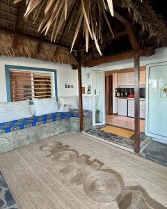 a room with a bed with a sign on the floor at MADIROKELY HOUSE Nosy Be in Ambatoloaka