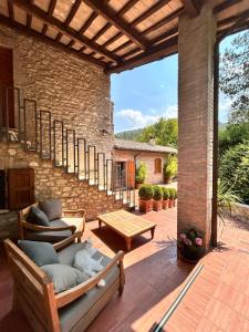 an outdoor patio with chairs and a table at Adagio Umbro in Sustrico Di Spoleto