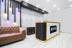 a living room with a couch and a tv at Hotel O Radha Krishna Residency in Nagri