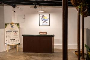 a podium in a room with a sign on the wall at Udupi River Inn in Kalyānpur +56 photos