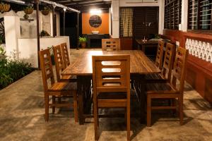 a wooden table and chairs in a room at Udupi River Inn in Kalyānpur