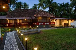 a house with lights in front of a yard at Udupi River Inn in Kalyānpur