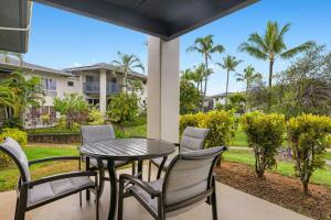 a table and chairs on a patio with a view of a yard at Club Wyndham Bali Hai Villas in Princeville +34 photos
