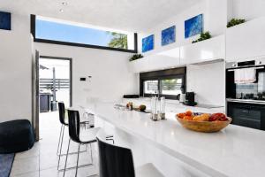 a kitchen with a bowl of fruit on a counter at Hillside Luxury Villas by NRAS in Finestrat