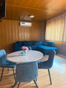 a living room with a table and chairs and a couch at VILLAGEbythelake Bicaz in Bicaz