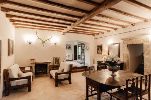 a living room with a table and chairs at B&B Palazzo Agrippa in Bominaco