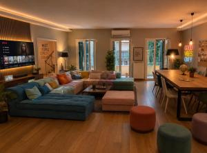 a living room with a blue couch and a table at BeachBox in Piraeus