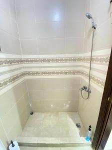 a bathroom with a shower with a tiled floor at بوابة جرش Jarash Gate in Jerash +58 photos