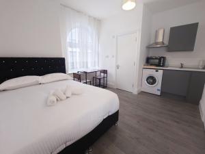 a bedroom with a large white bed with white pillows at Centra Station in London