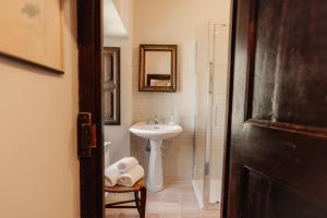 a bathroom with a sink and a mirror at B&B Palazzo Agrippa in Bominaco +26 photos