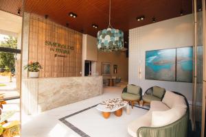 a lobby with a couch and chairs and a table at Smeralda del Mare by AFT in Porto De Galinhas