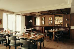 a dining room with wooden tables and chairs at The Kithmore in St. Andrews