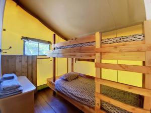a bedroom with a bunk bed in a house at Lodge La Belle Vie in Vigeois