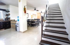 a staircase leading to a kitchen and a dining room at Stunning Large Remodeled Penthouse-Big Canal Views in Puerto Aventuras +13 photos