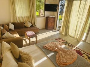 a living room with a couch and a tv at Sisi villa in Essaouira