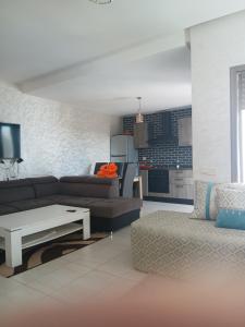 a living room with a couch and a table at Puerto banus beach Apt Famillies and married couples in Mansouria