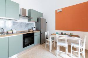 a kitchen with a table and chairs in a room at Poseidonia nel Borgo in Pulsano