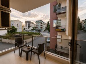 a balcony with chairs and a table and a view of a street at Pasha Residence in Trabzon