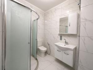 a bathroom with a toilet and a sink and a shower at Pasha Residence in Trabzon +18 photos