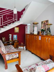 a living room with a couch and a staircase at Pousada São Nicolau in Cachoeira Paulista