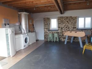 a kitchen with a ping pong table in a room at Le brin d'air Mayennais in Saint-Julien-du-Terroux