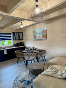 a living room with a table and chairs and a kitchen at Osada Mielenko in Mielenko