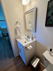 a bathroom with a sink and a mirror at Charming studio one mile from beach in Aptos +3 photos